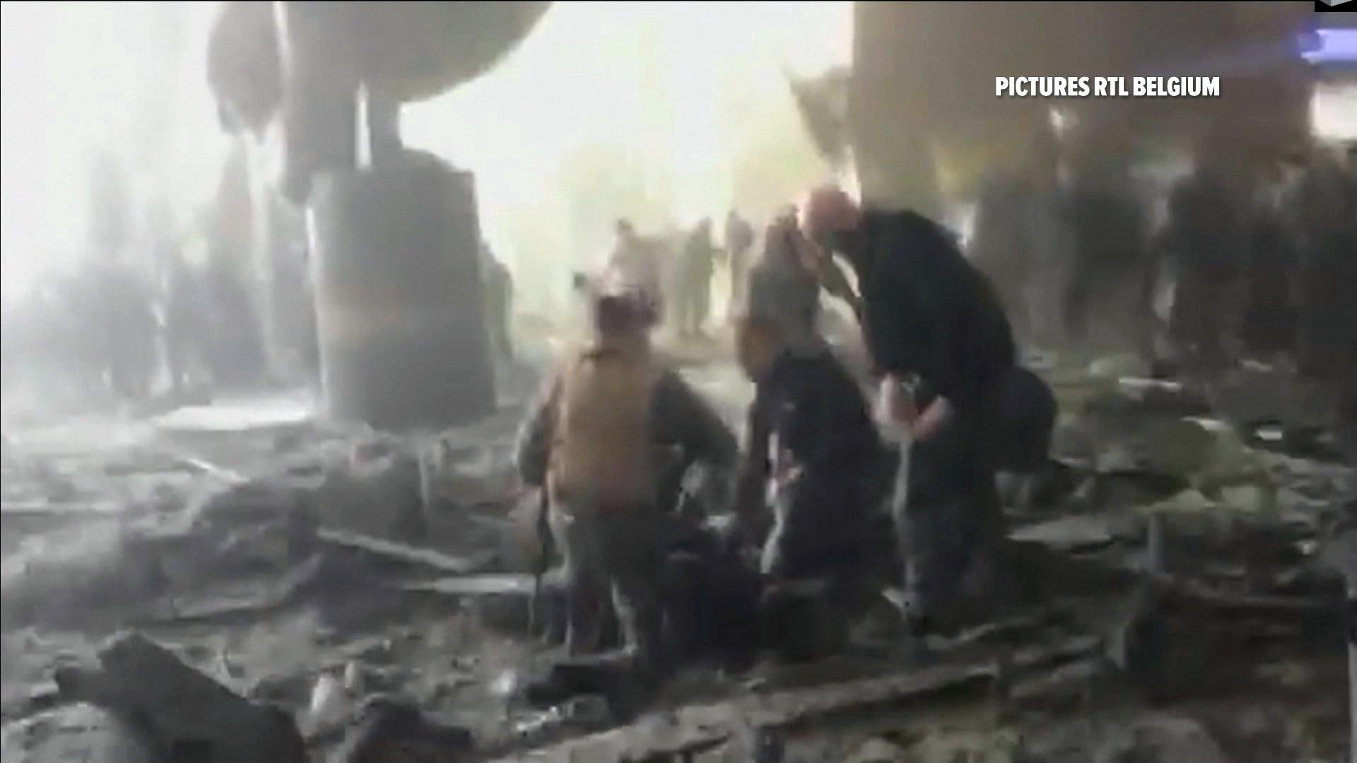 In this still image taken from video from RTL Belgium people receive treatment in the debris strewn terminal at Brussels Airport, in Brussels after explosions Tuesday, March 22, 2016. Authorities locked down the Belgian capital on Tuesday after explosions rocked the Brussels airport and subway system, killing a number of people and injuring many more. Belgium raised its terror alert to its highest level, diverting arriving planes and trains and ordering people to stay where they were. Airports across Europe tightened security. (RTL via AP) BELGIUM OUT TV OUT NO ARCHIVE 