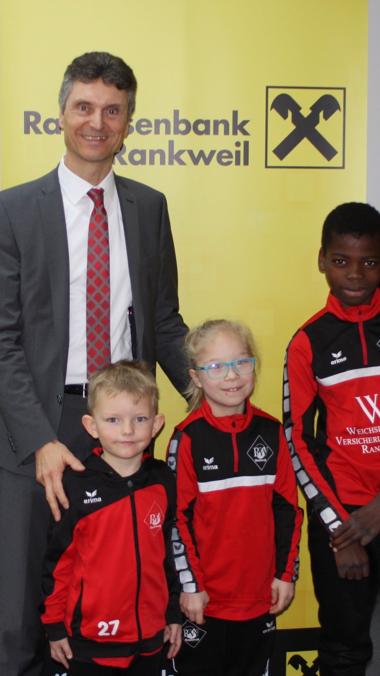 Bernd Breuss mit drei Spieler beim Hauptsponsor der Raika Rankweil auf Besuch