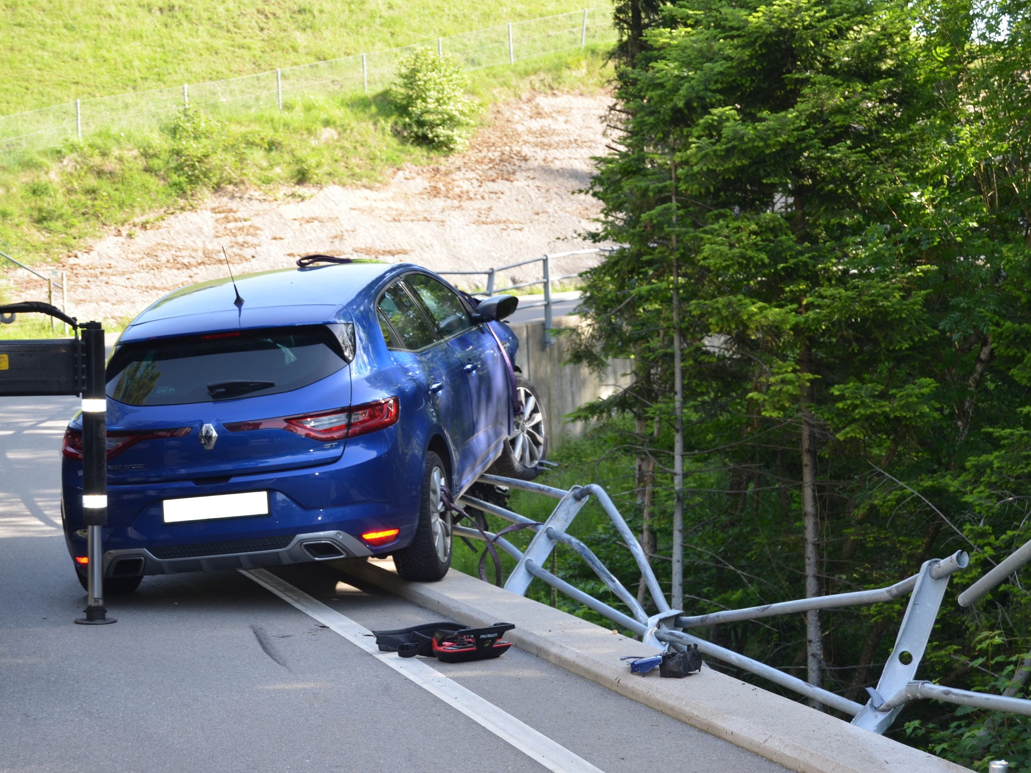 Das Auto blieb im Zaun hängen.