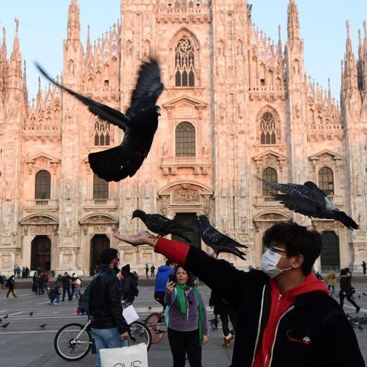 Menschen mit Schutzmasken vor dem Mailänder Dom