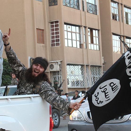 This file photo shows an image made available by Jihadist media outlet Welayat Raqa on June 30, 2014, allegedly showing a member of the IS (Islamic state) group parading in a street in the northern rebel-held Syrian city of Raqa.