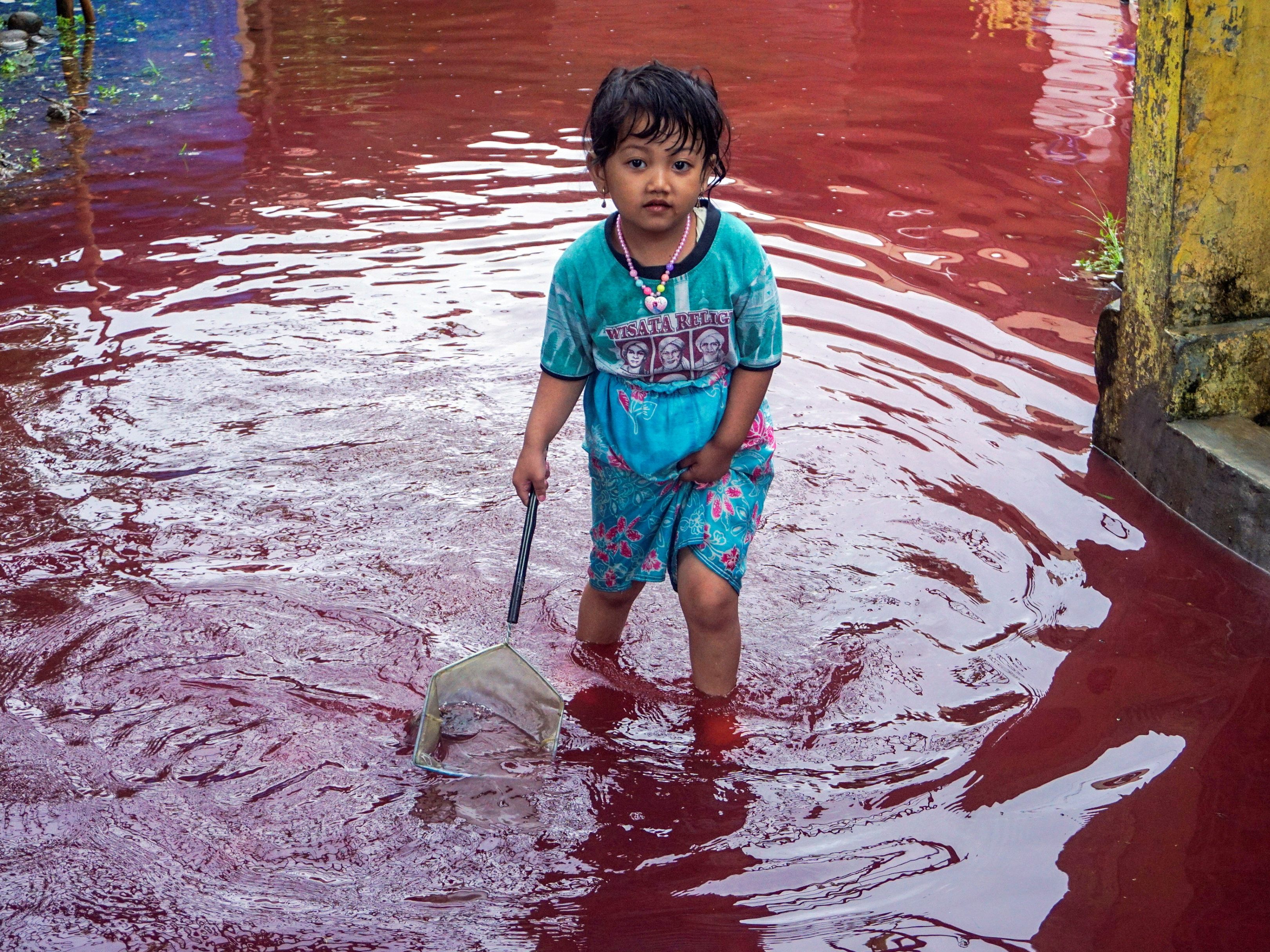 Blutrote Fluten: Farbiges Hochwasser überschwemmt Dorf in Indonesien.