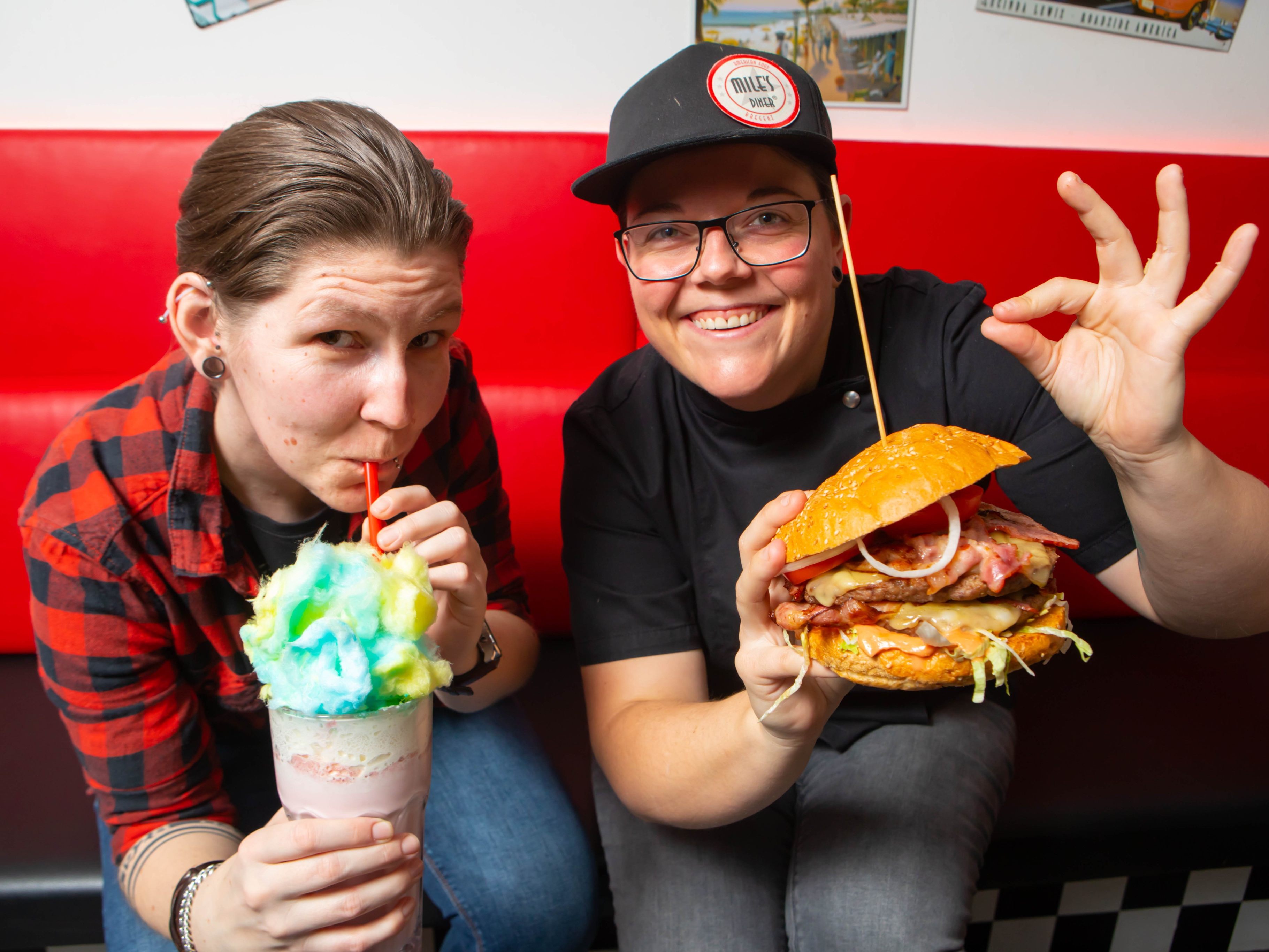Julia und Patricia stilecht mit Milkshake und Burger. Julia und Patricia stilecht mit Milkshake und Burger.